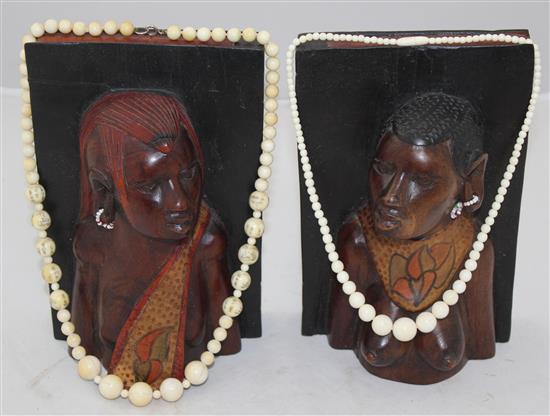 Ivory elephant on stand, a pair of bookends and two ivory bead necklaces